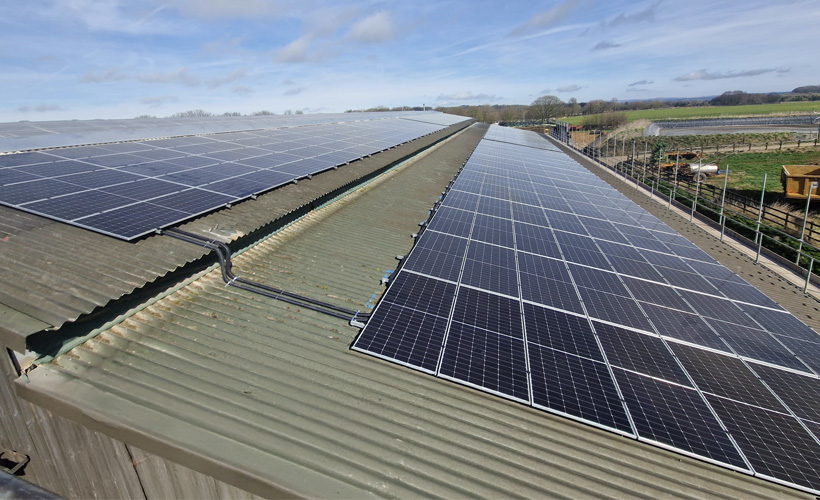 large farm building with solar array